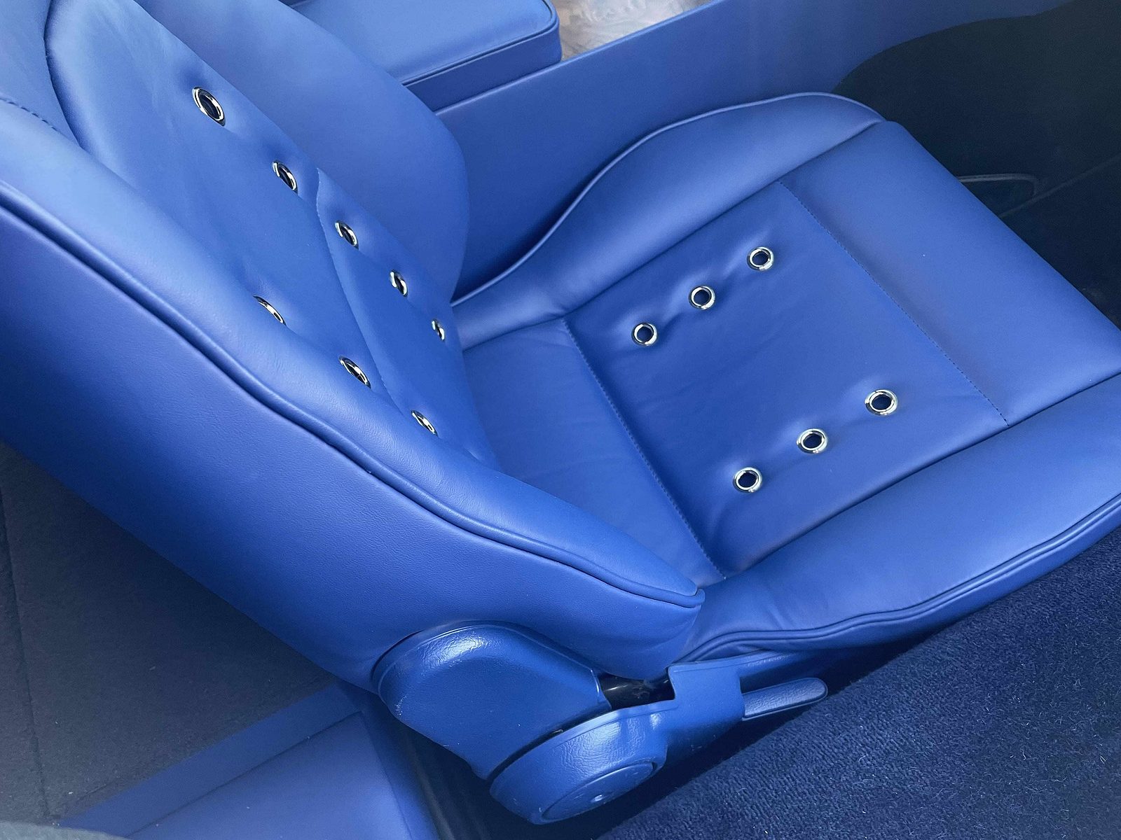 E-Type Re-Imagined — blue bucket seat with ventilated eyelets