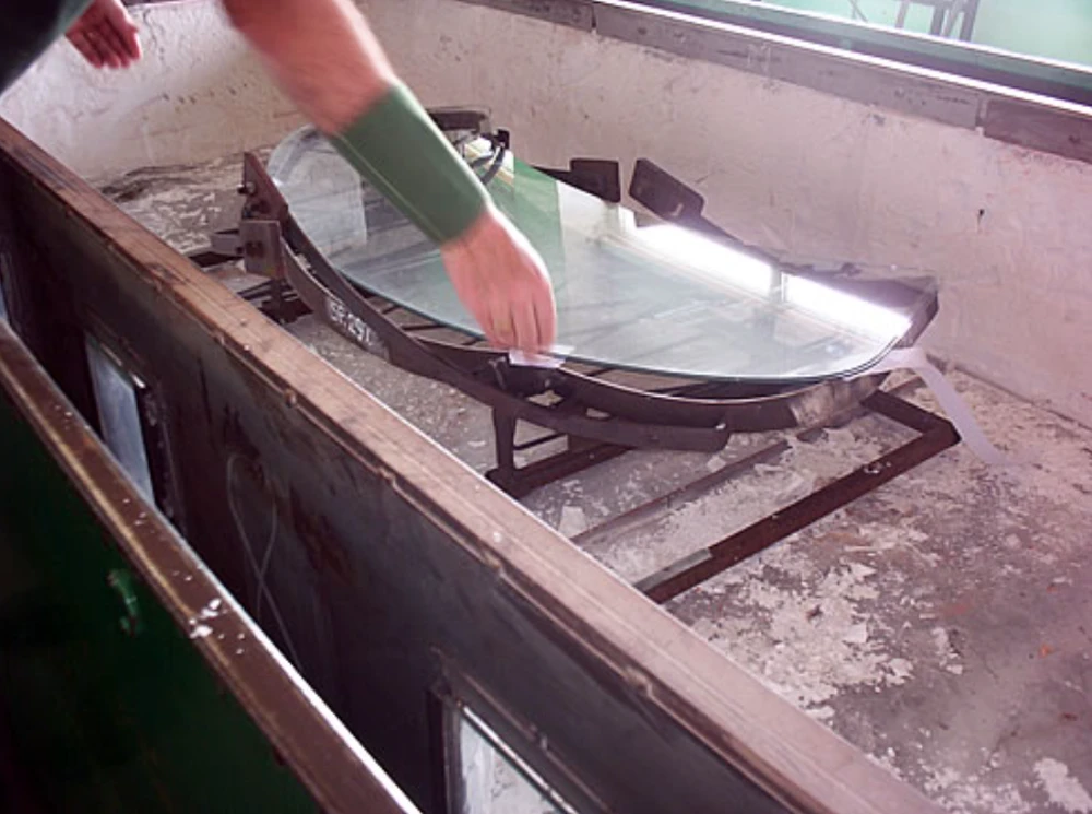 Jaguar XJ13 XJ13 glass "sandwich" being placed on top of original metal former. The whole assembly sits in a "trolley" ready for its journey through a series of heaters.